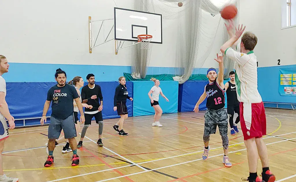 Adults basketball coached game with a professional basketball player and coach.